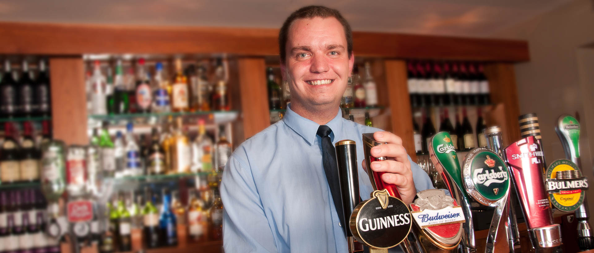 Barman pulling a pint in the bar in Aspect hotel Kilkenny